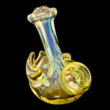 Load image into Gallery viewer, A yellow Horned Fumie Dot Stand-Up Spoon Pipe handblown by TKO Glassworks in the dark.