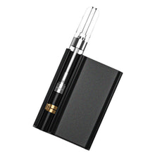 Load image into Gallery viewer, A black CCELL Palm Pro Battery with a dab cartridge inside it.