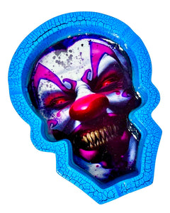 A blue and black Scary Clown Poly Stone Skull Ashtray.