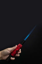 Load image into Gallery viewer, A red Eternity Flamesaber Torch Lighter in use.
