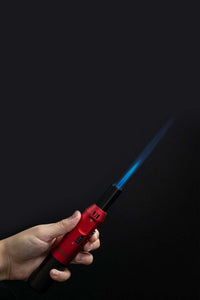 A red Eternity Flamesaber Torch Lighter in use.