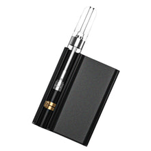 Load image into Gallery viewer, A black CCELL Palm Pro Battery with a dab cartridge inside it.
