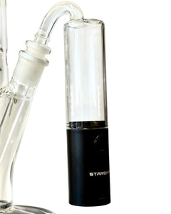 A Black Starship Triple Cartridge & Wax Coil Battery attached to a bong.